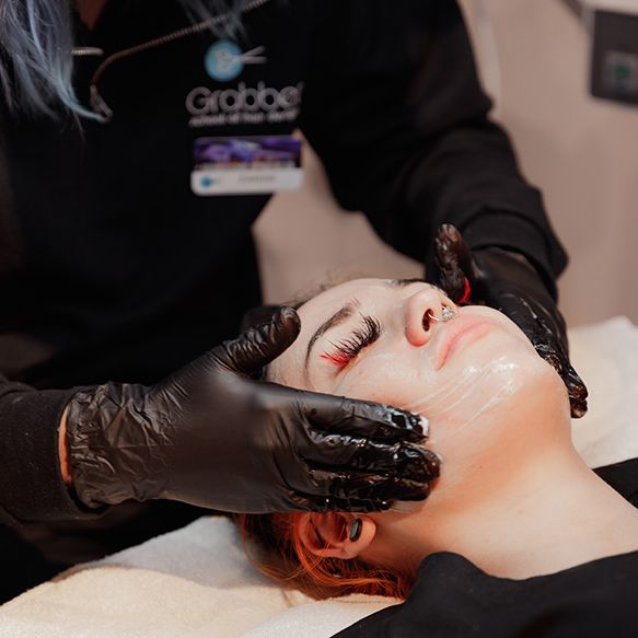 esthetician performing facial on student