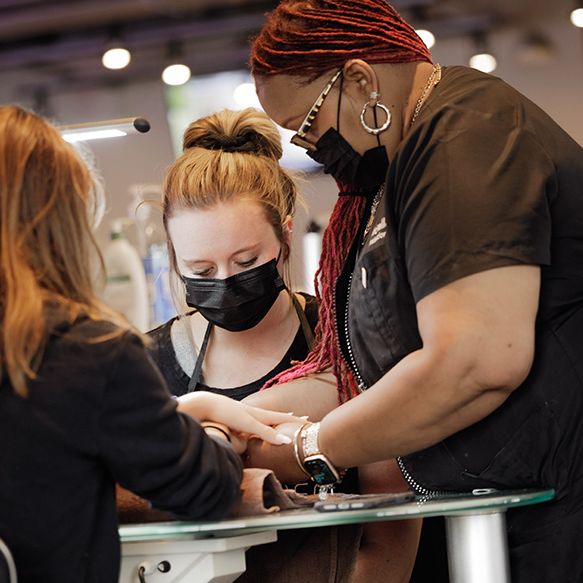 student and instructor manicuring customer