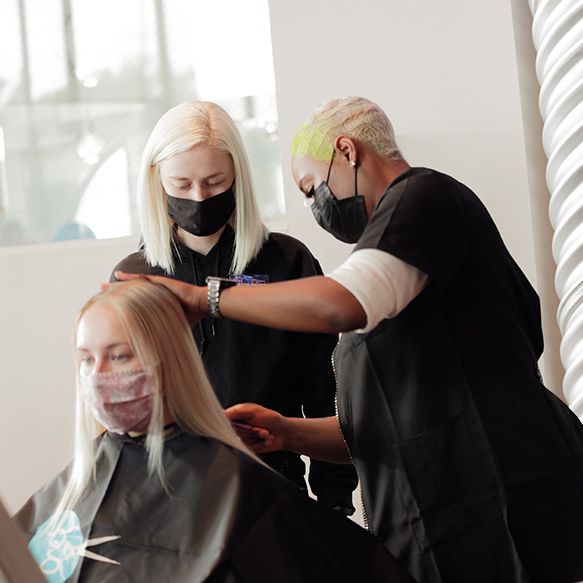 instructor showing student hair trimming technique
