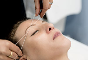 Salon Stylist Shaping Eyebrows