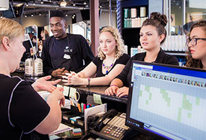 Shop Manager Checking out Clients
